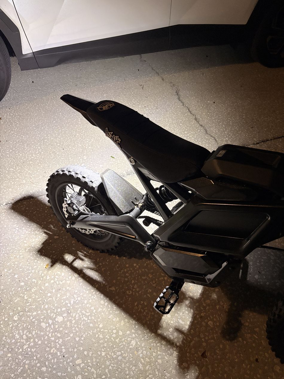 Surron style ebike lit up at night by WFD rock lights